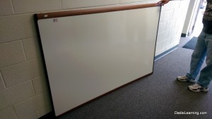 Used dry erase boards are a great way to save money.  Make sure to have some help for moving and installing the board.
