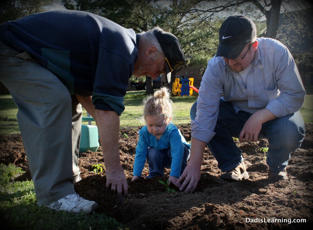 family planting garden